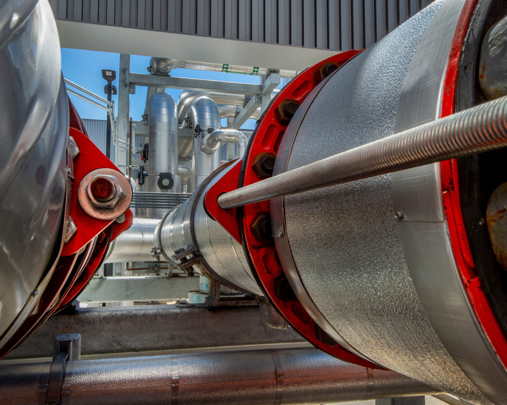 Industrial HVAC facility with chillers, pumps and associated plumbing.